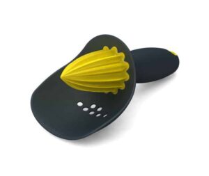 Manual citrus juicer with seed catcher by Joseph Joseph in grey and yellow