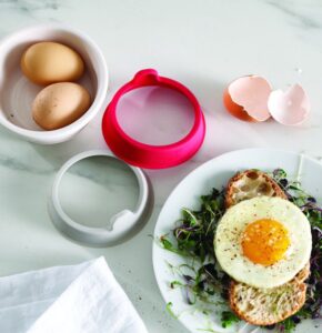 Silicone egg ring in grey and red by Joseph Joseph with easy-lift tabs
