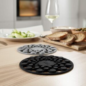 Joseph Joseph heat-resistant silicone trivets in grey and red with raised dot surface