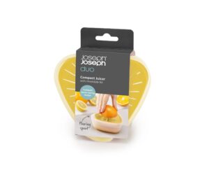 Compact citrus juicer in light yellow with reversible lid and spout by Joseph Joseph