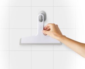 Compact shower squeegee with suction holder in white by Joseph Joseph, precision blade