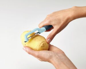 Swivel vegetable peeler by Joseph Joseph with stainless-steel blade and silicone handle